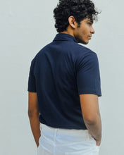 Load image into Gallery viewer, Male model is wearing navy blue Magnetic T-shirt, features magnetic buttons for easy wear. Adaptive clothing by Dawn Adaptive that makes dressing up easier.