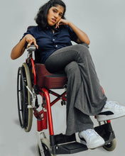 Load image into Gallery viewer, Female model in wheelchair is wearing navy blue Magnetic T-shirt, features magnetic buttons for easy wear. Adaptive clothing by Dawn Adaptive that makes dressing up easier.