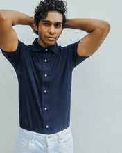 Load image into Gallery viewer, Male model is wearing navy blue Magnetic T-shirt, features magnetic buttons for easy wear. Adaptive clothing that makes dressing up easier.
