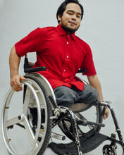 Load image into Gallery viewer, Male model in wheelchair is wearing red Magnetic T-shirt, features magnetic buttons for easy wear. Adaptive clothing by Dawn Adaptive that makes dressing up easier.
